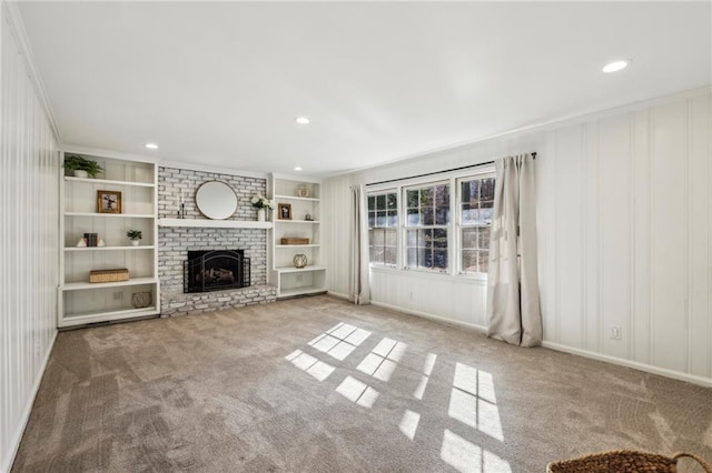 unfurnished living room featuring ornamental molding, light colored carpet, and a fireplace