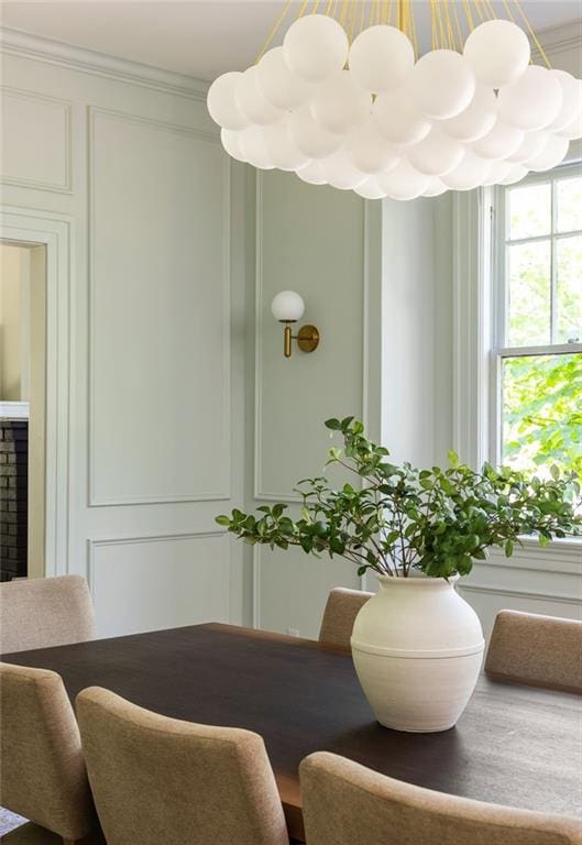 dining room featuring a fireplace and crown molding