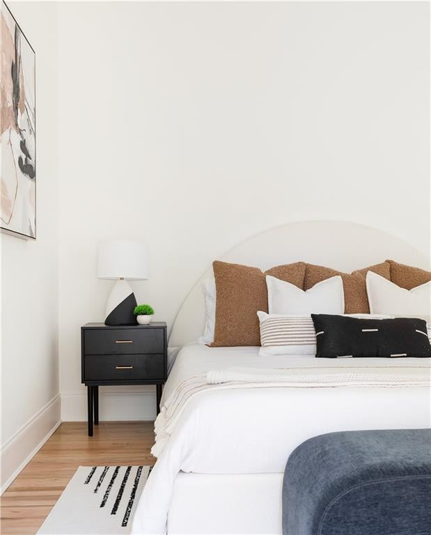 bedroom with wood finished floors and baseboards