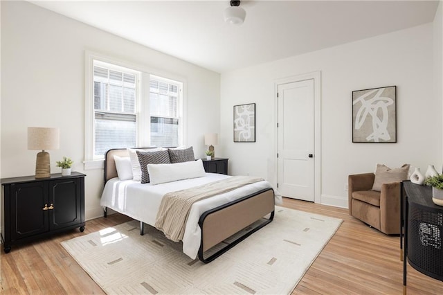 bedroom featuring light wood-style flooring and baseboards