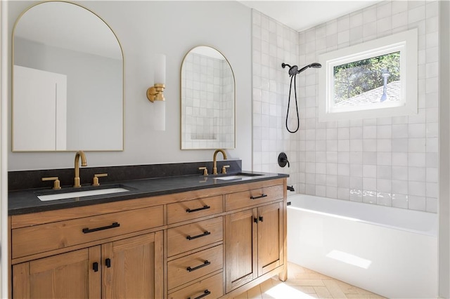 bathroom with double vanity, a sink, and shower / bathing tub combination