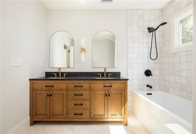 full bath with double vanity, visible vents, tub / shower combination, and a sink