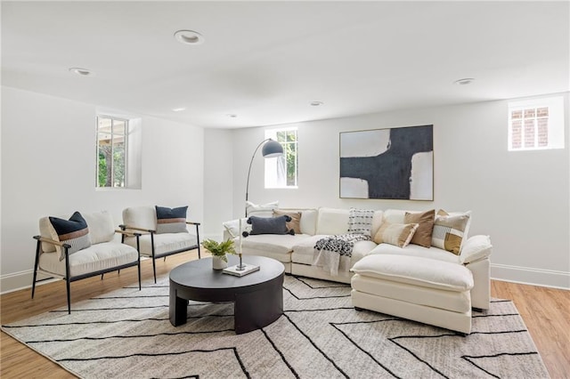 living room featuring recessed lighting, wood finished floors, and baseboards