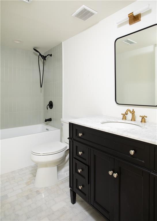 bathroom featuring  shower combination, visible vents, vanity, and toilet