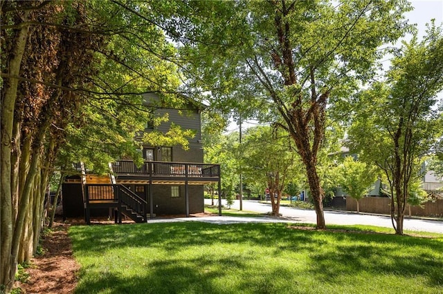 view of yard featuring stairway and a deck