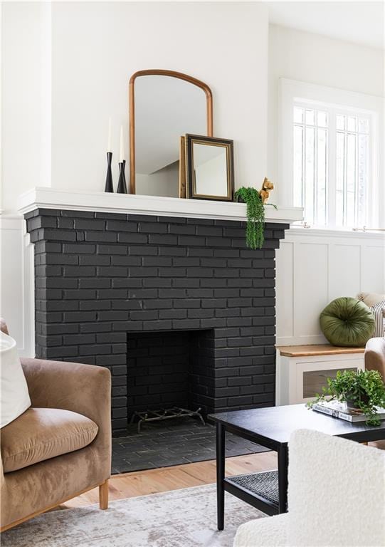 living area featuring a fireplace and wood finished floors