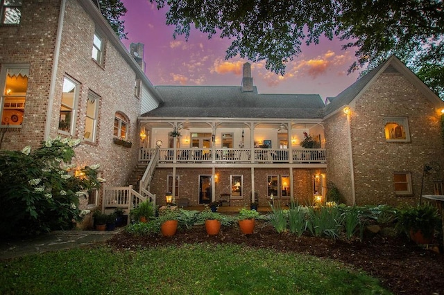 1145 Thurston Snow Rd, Good Hope, GA 30641 - rear view of house featuring brick siding, a chimney, stairs, and a balcony