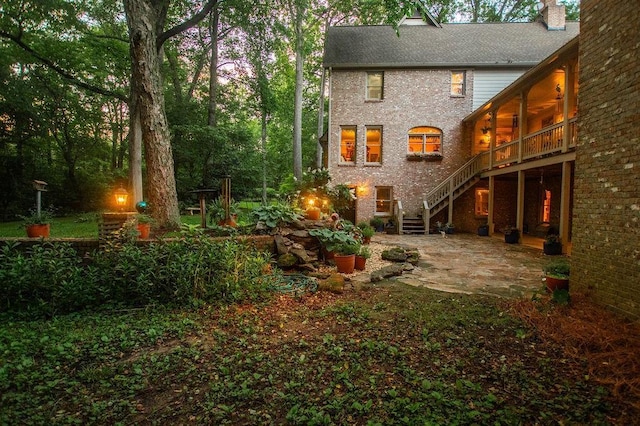 1145 Thurston Snow Rd, Good Hope, GA 30641 - rear view of house featuring a patio, stairway, a chimney, brick siding, and a deck