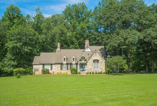 1145 Thurston Snow Rd, Good Hope, GA 30641 - tudor house featuring a front yard, stone siding, and a chimney