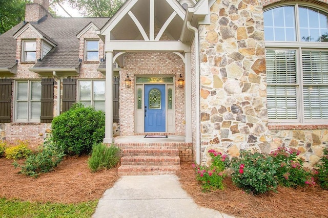 1145 Thurston Snow Rd, Good Hope, GA 30641 - property entrance with stone siding, a chimney, roof with shingles, and brick siding