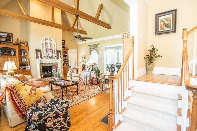1145 Thurston Snow Rd, Good Hope, GA 30641 - living room with high vaulted ceiling, stairway, a ceiling fan, a fireplace, and wood finished floors