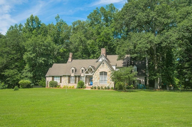 1145 Thurston Snow Rd, Good Hope, GA 30641 - tudor house with stone siding, a front yard, and a chimney