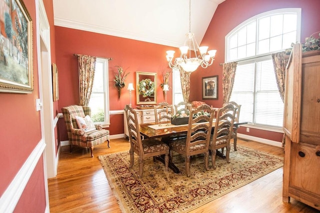 1145 Thurston Snow Rd, Good Hope, GA 30641 - dining area featuring a chandelier, plenty of natural light, lofted ceiling, light wood-style flooring, and ornamental molding