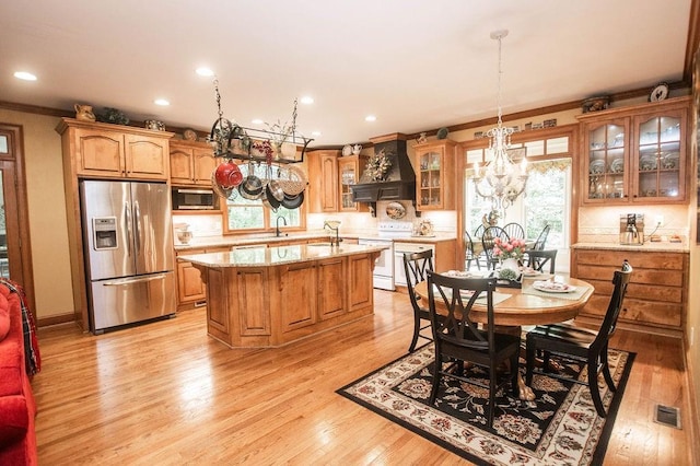 1145 Thurston Snow Rd, Good Hope, GA 30641 - kitchen featuring stainless steel appliances, premium range hood, a center island with sink, ornamental molding, and backsplash