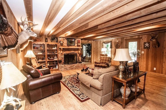 1145 Thurston Snow Rd, Good Hope, GA 30641 - living room with wood walls, wood finished floors, a brick fireplace, and beam ceiling