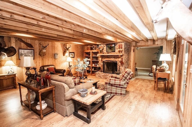 1145 Thurston Snow Rd, Good Hope, GA 30641 - living area with wooden walls, wood finished floors, a fireplace, and beamed ceiling
