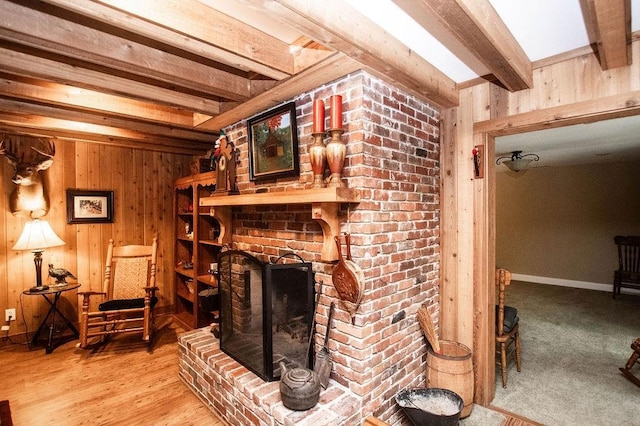 1145 Thurston Snow Rd, Good Hope, GA 30641 - living area featuring wood walls, beam ceiling, and a brick fireplace