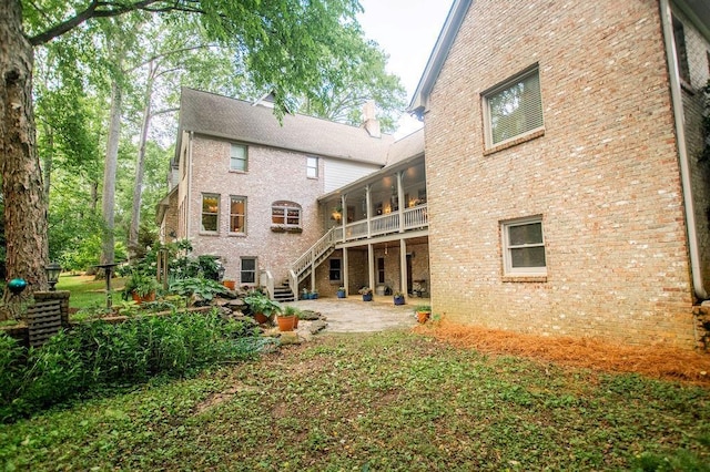 1145 Thurston Snow Rd, Good Hope, GA 30641 - back of house with stairway, a patio area, brick siding, and a chimney