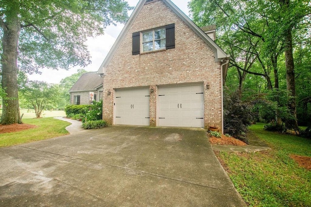 1145 Thurston Snow Rd, Good Hope, GA 30641 - view of side of property featuring brick siding, an attached garage, driveway, and a yard