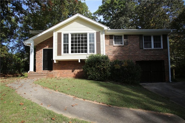 view of front of home with a garage, driveway, brick siding, and a front yard