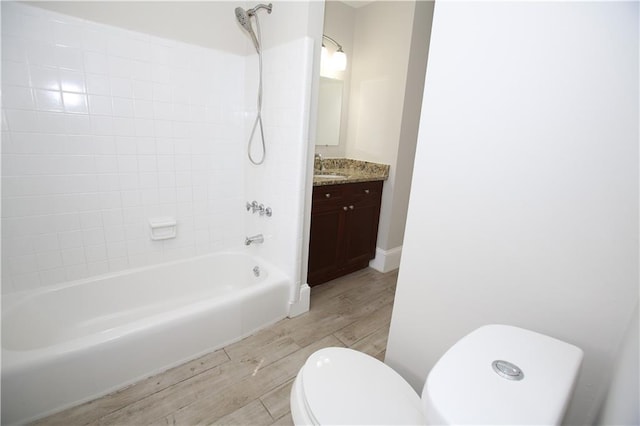 full bathroom featuring vanity, toilet, wood finished floors, and shower / bathtub combination