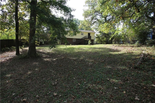 view of yard featuring stairs and fence