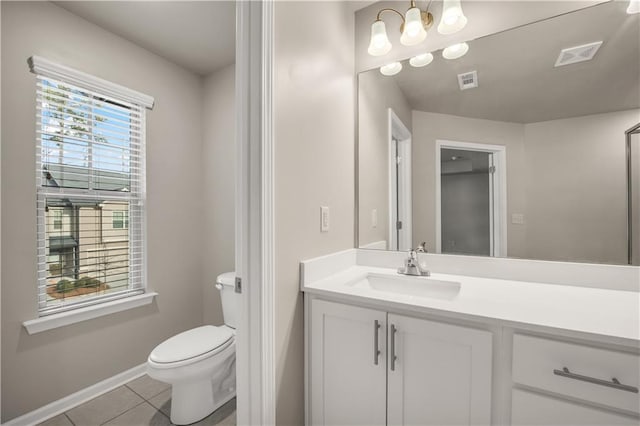 bathroom featuring tile patterned flooring, vanity, a notable chandelier, and toilet