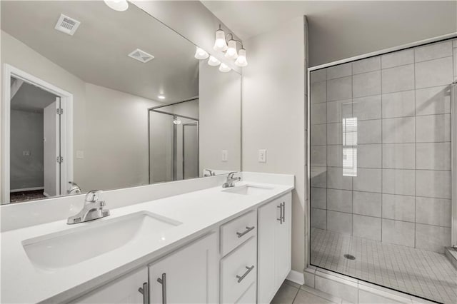 bathroom featuring tile patterned flooring, vanity, and a shower with door