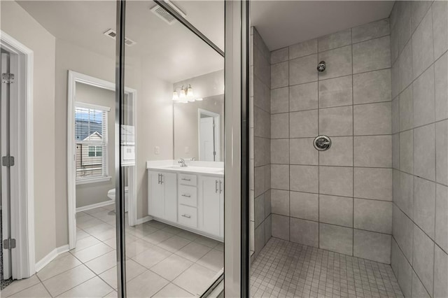 bathroom with vanity, tile patterned flooring, and toilet