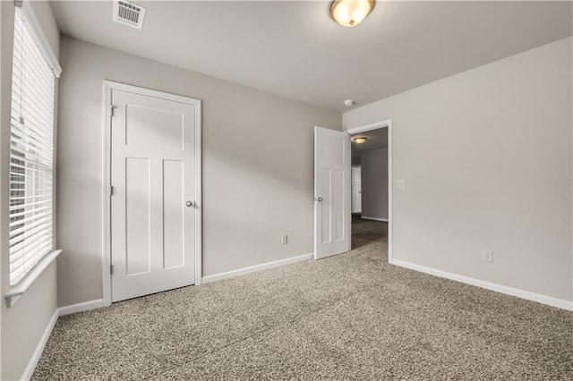 unfurnished bedroom with multiple windows and carpet floors