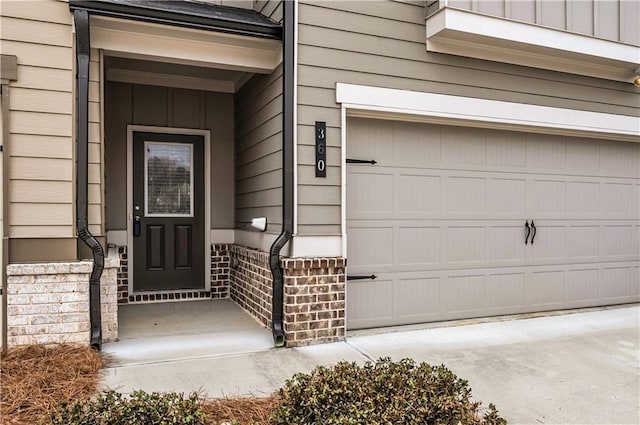 view of exterior entry with a garage