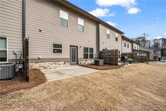 rear view of house featuring central AC unit and a patio area