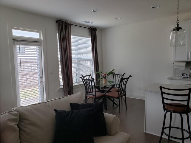 dining space with dark hardwood / wood-style floors and plenty of natural light