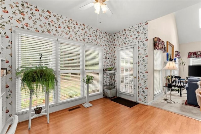 entryway featuring hardwood / wood-style flooring, ceiling fan, and a wealth of natural light