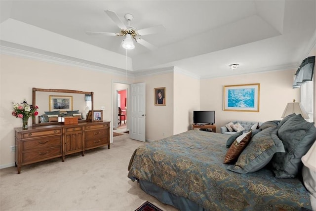 bedroom featuring a raised ceiling, light carpet, ceiling fan, and crown molding