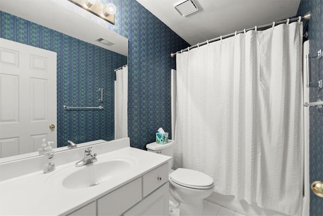 bathroom with toilet, tile patterned flooring, and vanity