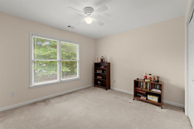 interior space with ceiling fan and light carpet