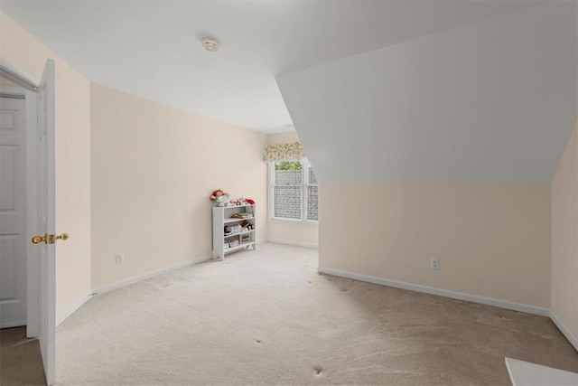 bonus room featuring lofted ceiling and light colored carpet