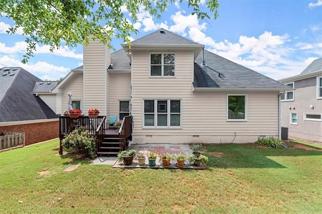 back of property featuring central AC, a deck, and a yard