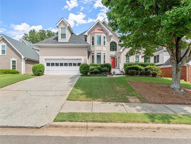 view of front of property with a front yard and a garage