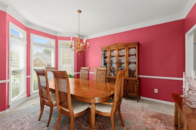 dining area featuring ornamental molding, a healthy amount of sunlight, and a notable chandelier