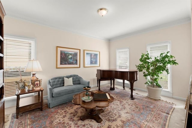 sitting room with carpet floors, crown molding, and a wealth of natural light