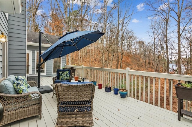 wooden terrace with an outdoor living space