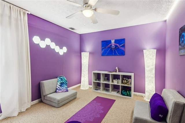 rec room featuring baseboards, visible vents, and a textured ceiling