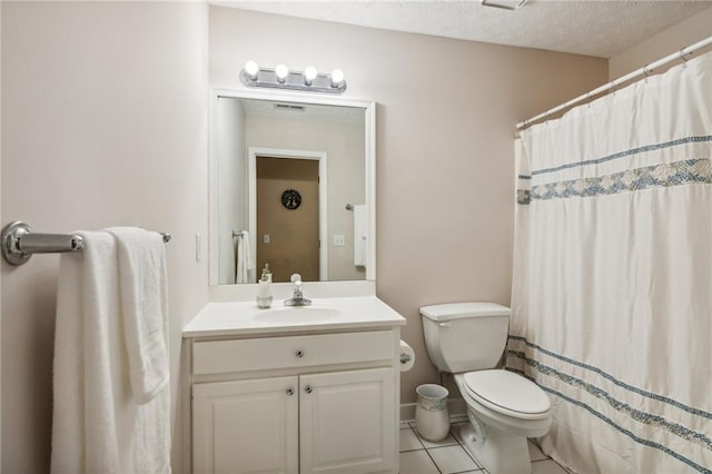 full bath featuring vanity, a shower with shower curtain, a textured ceiling, tile patterned floors, and toilet