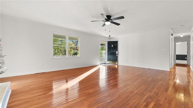 empty room featuring light wood-style flooring, baseboards, and a ceiling fan