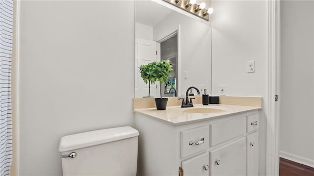 bathroom with toilet and vanity