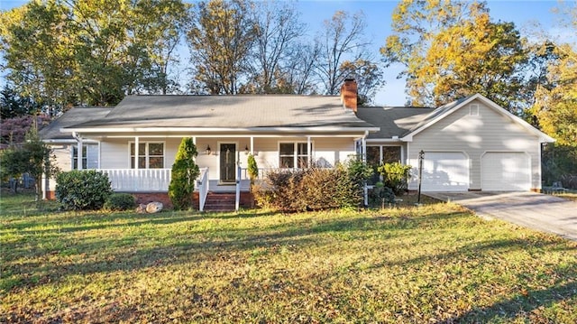 ranch-style home featuring a garage, a porch, concrete driveway, and a front yard