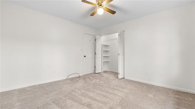 unfurnished bedroom with baseboards, a ceiling fan, and light colored carpet