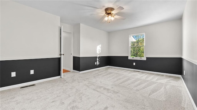 unfurnished room featuring light carpet, ceiling fan, visible vents, and baseboards